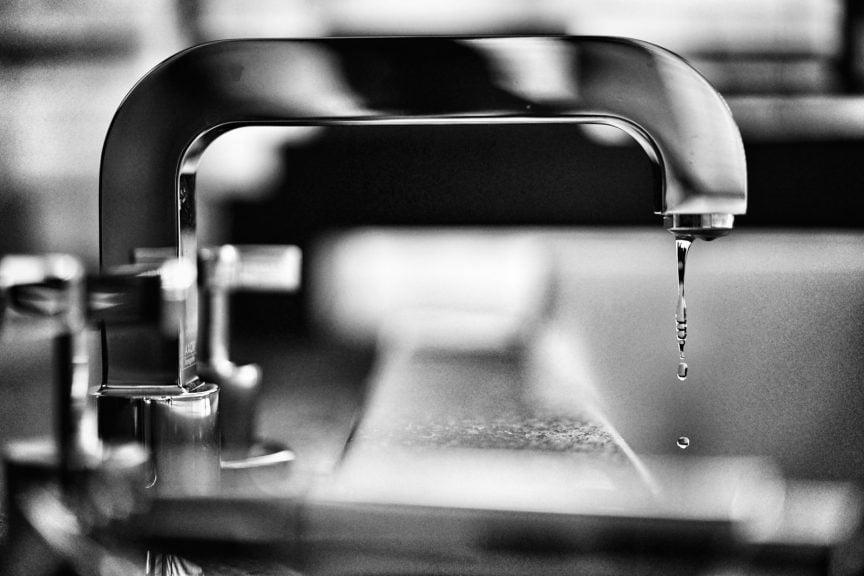 grayscale photography of faucet